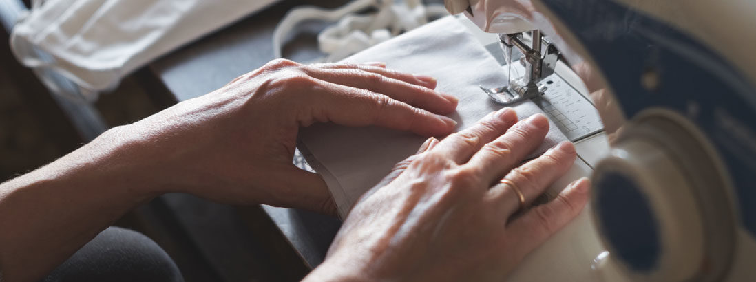 woman sews healthcare masks