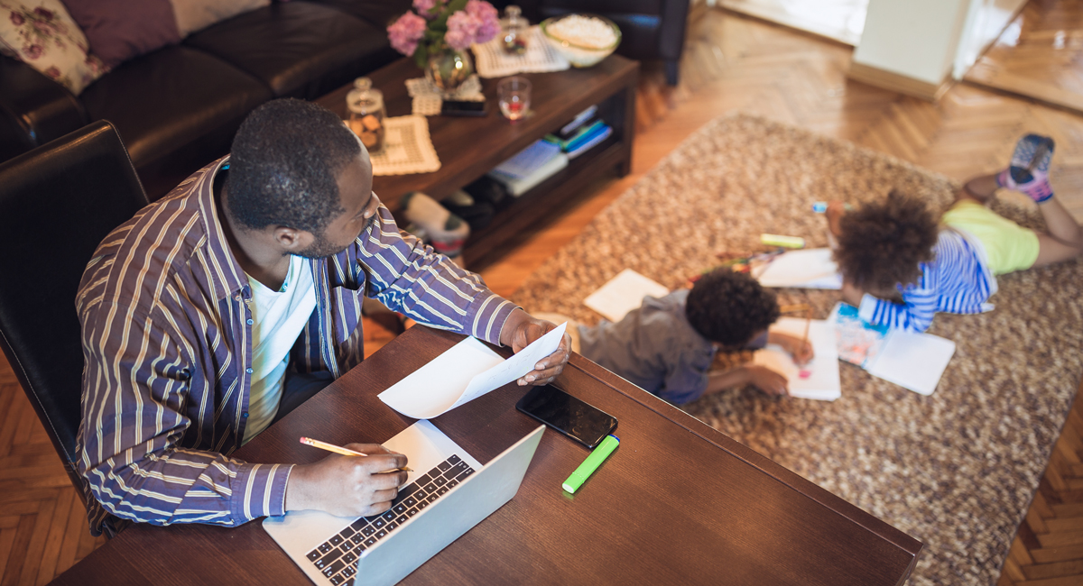 father working from home with children