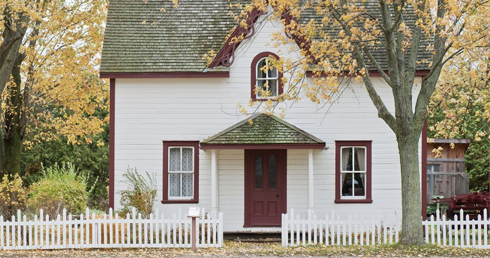 small white house on a fall day