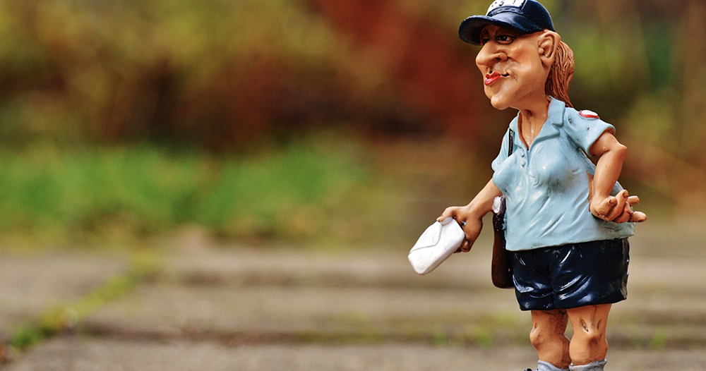 lawn statue of a USPS worker