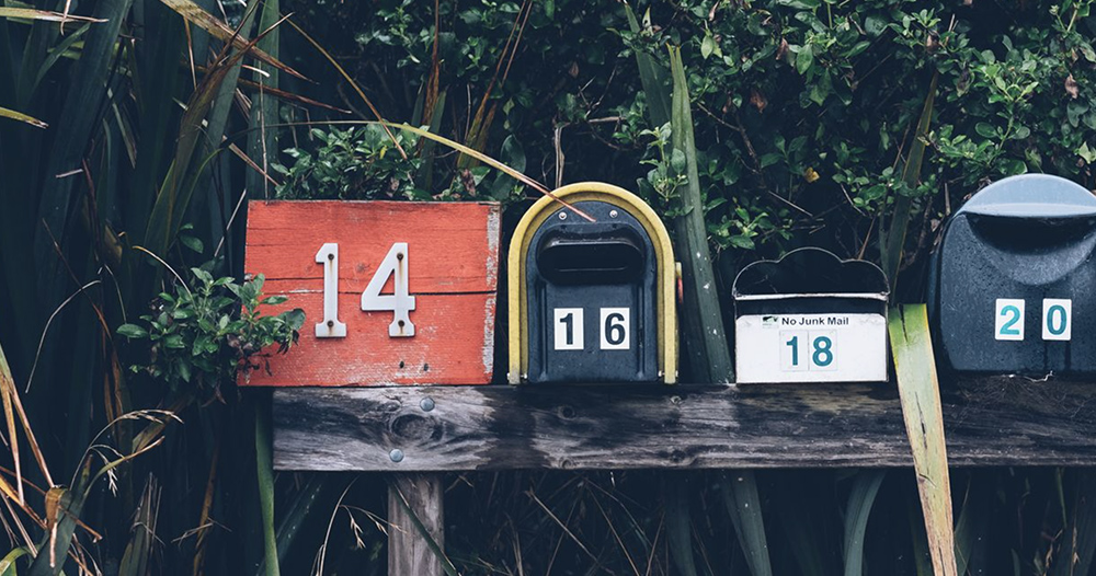 a series of mailboxes on the side of a street