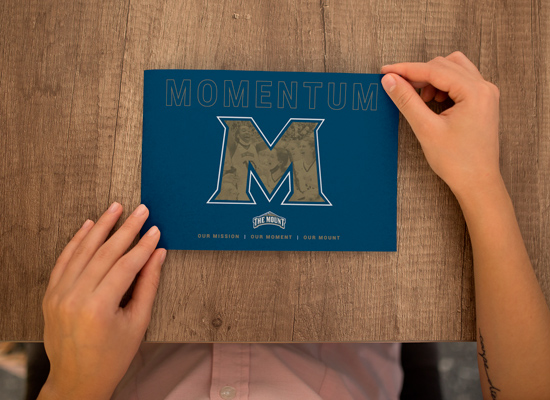 front of dark blue MSMU booklet cover with die-cut gold M lettering