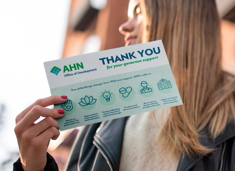 woman holding thank you card