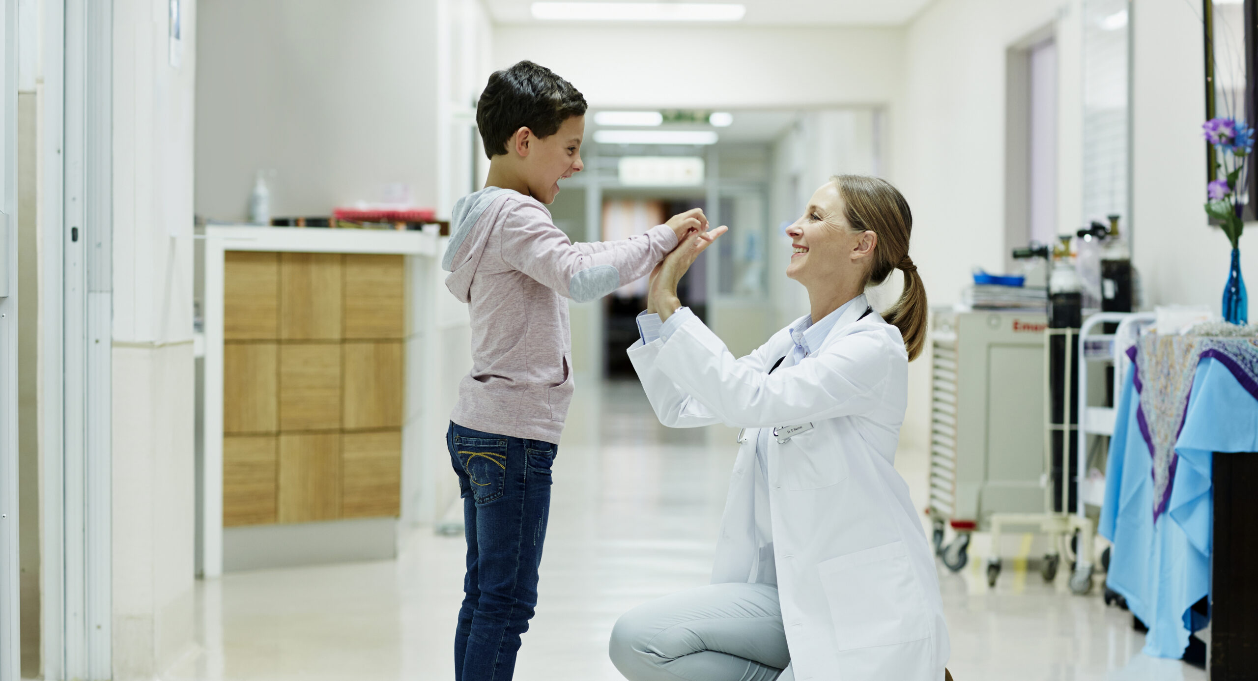 female doctor giving a young male patient a high five